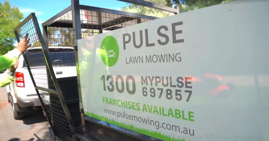 pulse mowing ute and trailer at a house